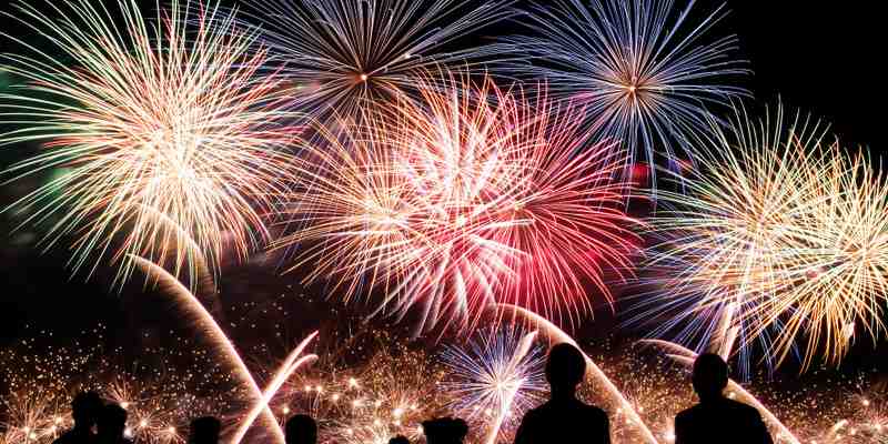 A crowd of people watching fireworks