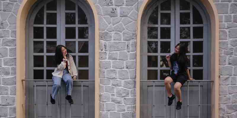 Girls waving to each other