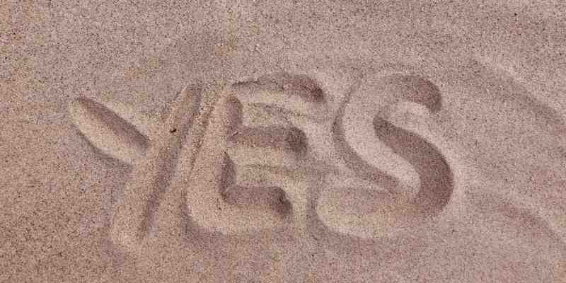 'yes' written in sand